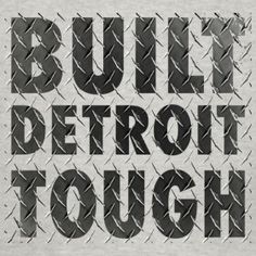 the words built detroit tough on a chain link fence