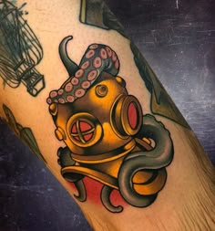 an octopus with a gas mask tattoo on his leg is shown in front of a man's arm