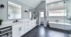 a large bathroom with two sinks and a bathtub