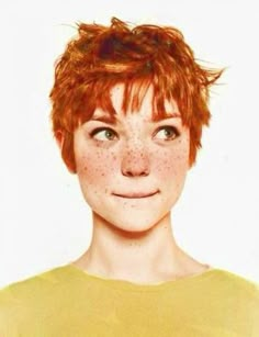 a woman with freckles on her face looking at the camera