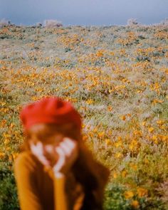 a person standing in a field with yellow flowers