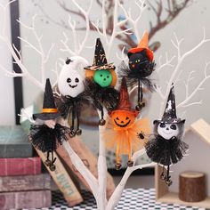 a group of halloween decorations sitting on top of a tree