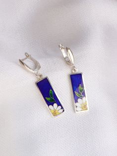 100% handmade sterling silver earrings, covered with hot cloisonné enamel. Cloisonné  is an ancient technique for decorating metalwork objects with colored material held in place or separated by metal strips or wire, normally of gold or silver. This process is quite laborious, because all the details require hand processing. Georgian cloisonné enamel counts more than 1200 years of history.  Our handmade pendants, earrings, brooches are vibrant with colour and compliment any outfit, prefered for daily wear or a special occasion. Materials: Sterling Silver, Fine Silver, Cloisonne enamel Weight - 4.8 gr (approx) Drop Lenght - 1.7 cm; 0.7 inches  Lenght - 3 cm; 1.2 inches Width - 1.5 cm; 0.6 inches  About it: Our jewelry pieces are created using a combination of enameling and metal clay techni Silver Flower Enamel Earrings, Silver Enamel Flower Earrings For Pierced Ears, Silver Flower Earrings With Enamel For Pierced Ears, Hand Painted Sterling Silver Earrings For Gift, Silver Enamel Flower Earrings As Gift, Flower Earrings Dangle, Dangle Silver Earrings, Cloisonne Jewelry, Cloisonne Earrings