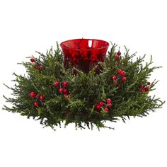 a red glass candle holder with holly and berries