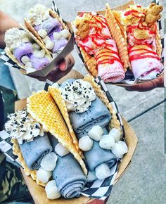 three different types of ice cream sandwiches in paper containers with waffle cones and marshmallows