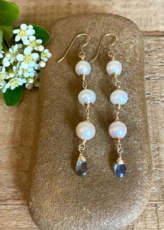 Gold filled dangle earrings with white freshwater pearls and faceted labradorite gemstones Briolette Pearl Jewelry With Natural Stones, Handmade Briolette Pearl Earrings, Handmade Long Drop Pearl Jewelry, Pearl Dangle Earrings With Natural Stones, White Faceted Dangle Earrings, Pearl Briolette Earrings, Natural Stone Dangle Pearl Earrings, White Dangle Earrings With Faceted Details, White Faceted Briolette Jewelry