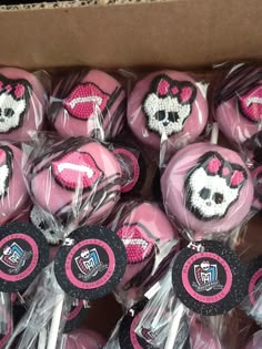 a box filled with pink and black lollipops