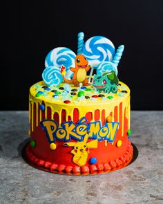 a pokemon themed birthday cake with lollipops and candies on the top