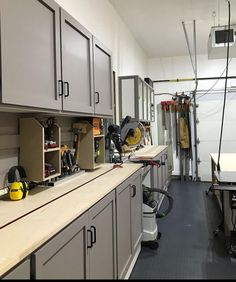 a room with lots of work tools and cabinets