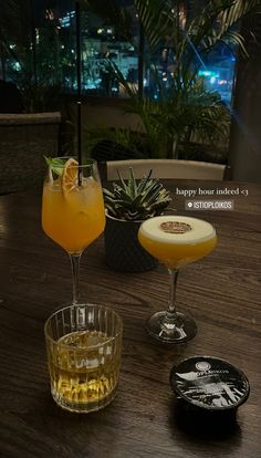 two drinks sitting on top of a wooden table