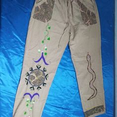 The Peruvian Hand-Embroidered Pants Have A Drawstring At The Waist To Regulate It. You Can Also See In The Images That You Have Four Pockets, Two On The Front And Two On The Back Embroidered On Fresh Fabric With Patterns From The Shipiba Culture From Amazon Jungle Measure 24 Width Length 41", 15" Waist Bohemian Embroidered Straight Leg Pants, Bohemian Straight Pants With Floral Embroidery, Bohemian Floral Embroidered Trousers, Bohemian Cotton Pants With Floral Embroidery, Bohemian Long Pants With Floral Embroidery, Embroidered Cotton Straight Leg Pants, Traditional Spring Pants With Pockets, Bohemian Pants With Floral Embroidery, Summer Embroidered Cotton Harem Pants