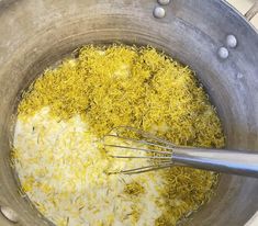 the food is being prepared in the pot with whisks and seasonings on it