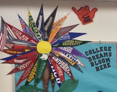 a bulletin board decorated with colorful flags and a sunburst on the front wall