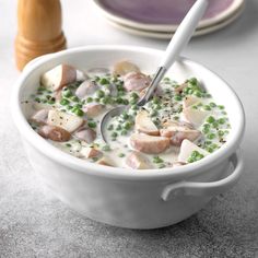 a white bowl filled with soup and peas