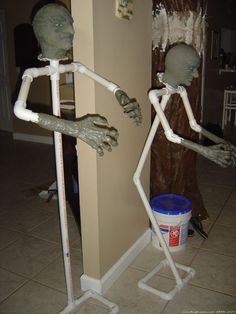 two fake halloween figures standing next to each other