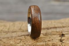 a wooden ring sitting on top of a piece of wood