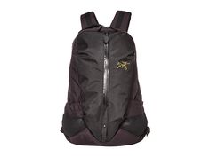 a black backpack with an embroidered cross on the front and zippers at the bottom