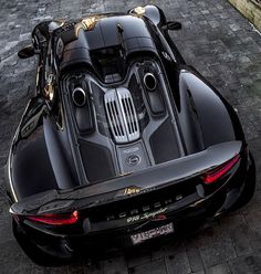 a black sports car is parked on the street