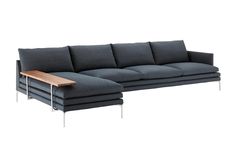 a gray couch with a wooden table on it's back end and side legs