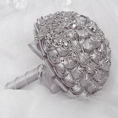 the bridal bouquet is made up of silver ribbons