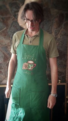 a man wearing an apron with a cup on it