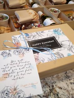 an open box filled with lots of food next to a card and some other items