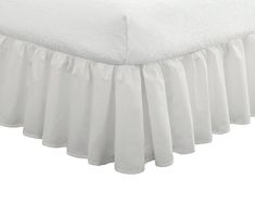 a white bed skirt with ruffled edges