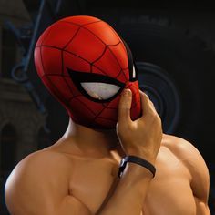 a close up of a person wearing a spider - man mask talking on a cell phone