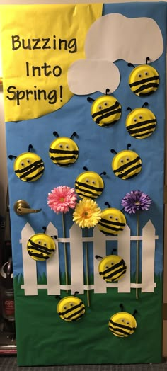 a bulletin board with bees and flowers in the grass, on top of a fence