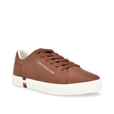 Tommy Hilfiger-Ramoso Sneaker Achieve a classic look with the Tommy Hilfiger Ramoso sneaker. Apart from the timeless profile, this lace-up sneaker has a signature stripe that adds to the authenticity. The memory foam insole keeps you comfortable as you move. Brown Sneakers With Contrast Sole For Spring, Brown Textured Sole Sneakers For Spring, Spring Brown Sneakers With Contrast Sole, Brown Lace Sneakers For Spring, Brown Cushioned Sneakers For Spring, Tommy Hilfiger Cushioned Sneakers In Synthetic Material, Sporty Tommy Hilfiger Low-top Sneakers, Tommy Hilfiger Low-top White Sole Sneakers, Tommy Hilfiger Sporty Sneakers With Perforated Toe Box