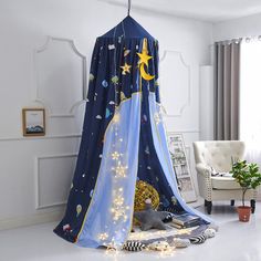 a child's play tent with stars and planets on it in a white room