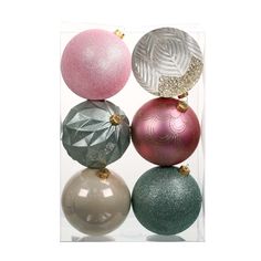 three different colored ornaments in a clear box