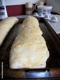 bread is being prepared on a baking sheet