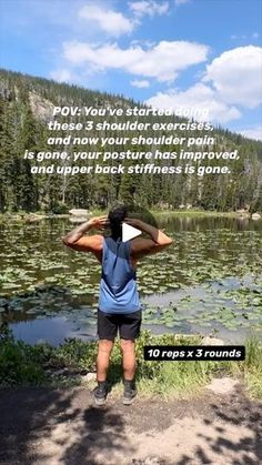 a woman standing in front of a lake with her back to the camera and text on it