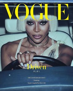 a magazine cover featuring a woman driving a car with her hand on the steering wheel