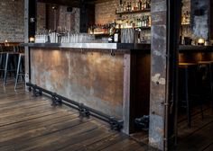 a bar with lots of bottles and stools