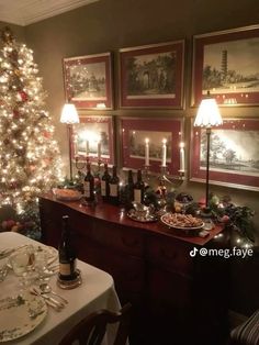 a dining room with a christmas tree and pictures on the wall