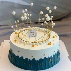 a cake decorated with pearls and a tiara