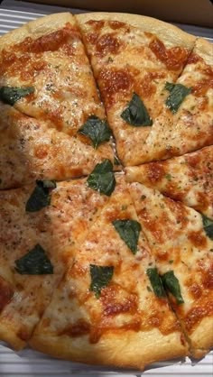 a pizza sitting on top of a pan covered in cheese and spinach toppings