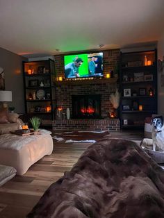 a living room filled with furniture and a flat screen tv mounted on the wall above a fireplace