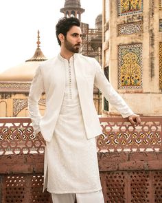 A classic white shalwar kameez featuring tonal embroideries in stripes. Crafted from a self geometric fabric the waistcoat sits on top, carefully embellished on the collar. NOTE: All our items are handmade and specially customized for our beautiful customers. Please expect minor variations in the actual product as compared to the image displayed. We make it exclusively using similar fabrics. Product color may slightly vary due to photographic lighting sources or your monitor settings. No return No exchange. Dry cleaning only White Lenin Kurta For Men, Nikah Kurta For Men, White Indian Outfit Men, Barat Outfit Men, Kurta White Men, Kurta Waistcoat Men Wedding, White Kurta Pajama Men With Jacket, Mens Nikkah Outfit, Nikkah Outfit Men