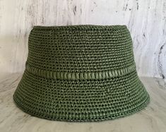 Crocheted green raffia hat It is a classic accessory for sun protection, summer parties, beach and travel. The hat is crocheted from natural raffia, light, elastic, small fields of the hat are reinforced with wire. The hat keeps its shape well and does not fade in the sun. The cap is soft to the touch, slightly rough. It is fully crocheted. Easy to carry with foldable design. The hat is perfect for summer wardrobe. Field Size: about 2,4 inches (6 cm) Care of the product:        It is better to dry the hat naturally, without using additional heating sources. When the raffia product dries, it returns to its original shape.        You cannot wash them in the usual way. If it gets dirty, clean it with soapy water and a sponge. The surface is gently wiped and left to dry in the shade. Items sho Crochet Raffia Hat, Rafia Hat, Italian Hat, Unisex Crochet, Raffia Sun Hat, Crochet Hat With Brim, Hippie Hat, Crochet Sun Hat, Knit Beret