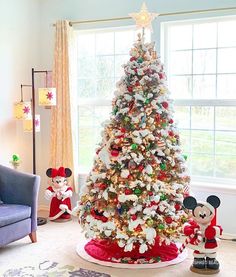 a decorated christmas tree with mickey mouse figurines