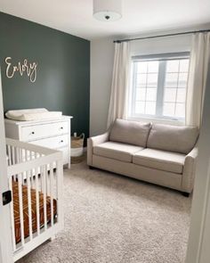 a baby's room with a crib and couch