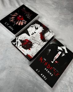 two book covers with blood on them sitting on a white bed sheet, next to each other