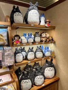 many totoro stuffed animals are on shelves