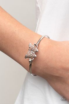 Attached to a shiny silver bangle-like bracelet, a silver butterfly flutters atop the wrist for a dainty fashion. Features a hook and eye closure.

Sold as one individual bracelet. Dainty Fashion, Rose Gold Butterfly, Rose Gold Bangle, Butterfly Bracelet, Hook And Eye, Paparazzi Accessories, Silver Butterfly, A Hook, Gold Butterfly