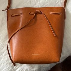 Tan Mansur Gavriel Bucket Bag With Light Pink Interior. Scratches On Bag From Belts, Keys, Etc But In Decent Shape Overall. Beautiful Patina. Light Pink Interior, Mansur Gavriel Bucket Bag, Mansur Gavriel Bag, Pink Interior, Mansur Gavriel, Bucket Bag, Crossbody Bags, Belts, Patina