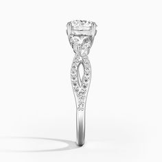 a diamond ring with an intricate design on the side