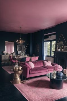 a living room filled with furniture and a pink rug